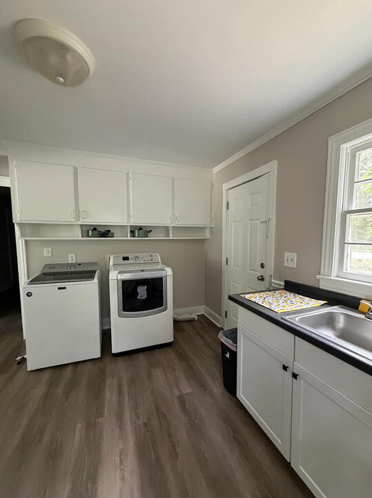 Pasadena Avenue kitchen and laundry Pasadena Avenue kitchen with white cabinets, a sink, and a washer and dryer